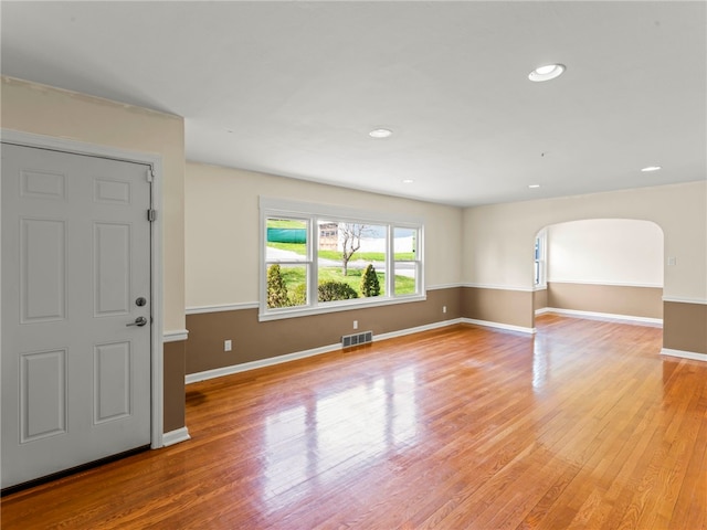 320 Parcell St, Claysville, PA 15323 - interior space with baseboards, arched walkways, visible vents, and light wood-style flooring