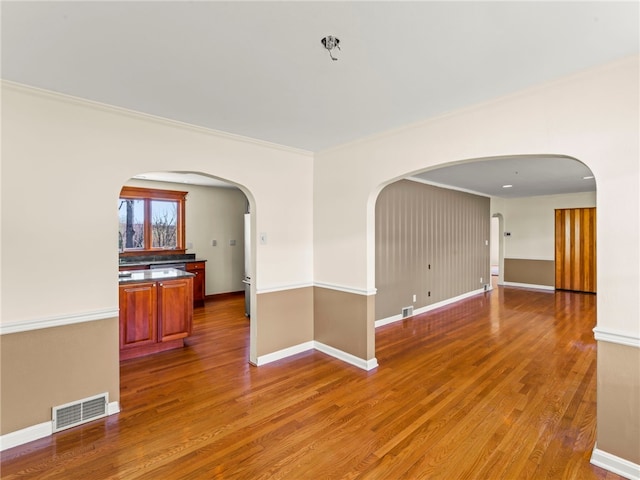 320 Parcell St, Claysville, PA 15323 - unfurnished room featuring wood finished floors, visible vents, arched walkways, and crown molding