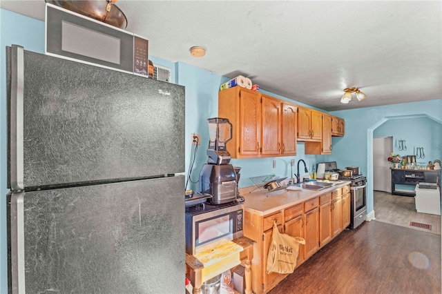 335 Queensbury Steet, Crafton Heights, PA 15205 - kitchen with dark wood finished floors, light countertops, a sink, arched walkways, and appliances with stainless steel finishes