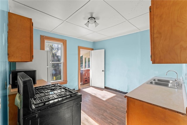 335 Queensbury Steet, Crafton Heights, PA 15205 - kitchen with wood finished floors, gas stove, a sink, and brown cabinets