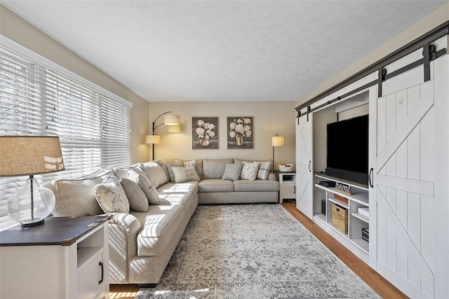 158 Edgemeade Dr, Monroeville, PA 15146 - living area with wood finished floors, a textured ceiling, and a barn door