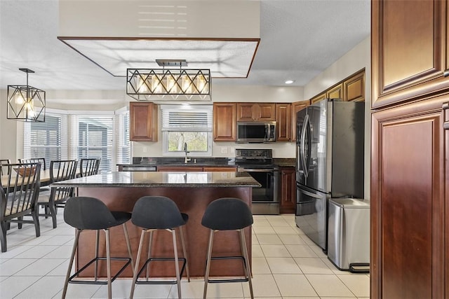 158 Edgemeade Dr, Monroeville, PA 15146 - kitchen with stainless steel appliances, a sink, light tile patterned flooring, a center island, and a kitchen bar