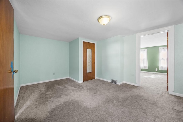 empty room with carpet flooring and baseboards
