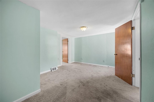 carpeted empty room with baseboards