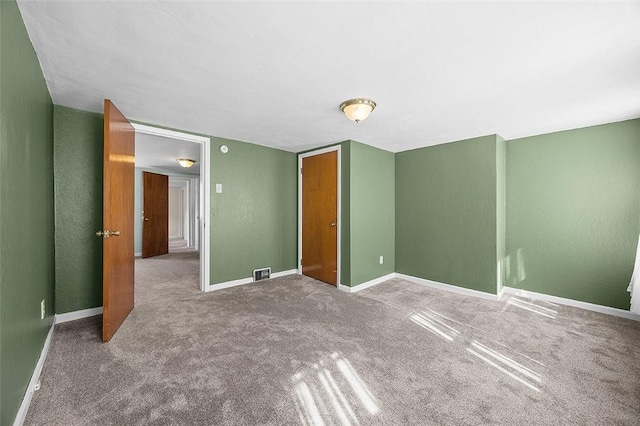 unfurnished bedroom featuring baseboards and carpet