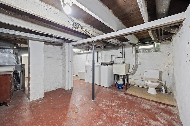 below grade area featuring independent washer and dryer and a sink