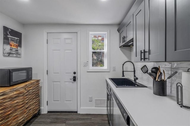 3906 Meadowbrook Blvd, Brentwood, PA 15227 - kitchen featuring a sink, decorative backsplash, black microwave, light countertops, and dark wood-type flooring