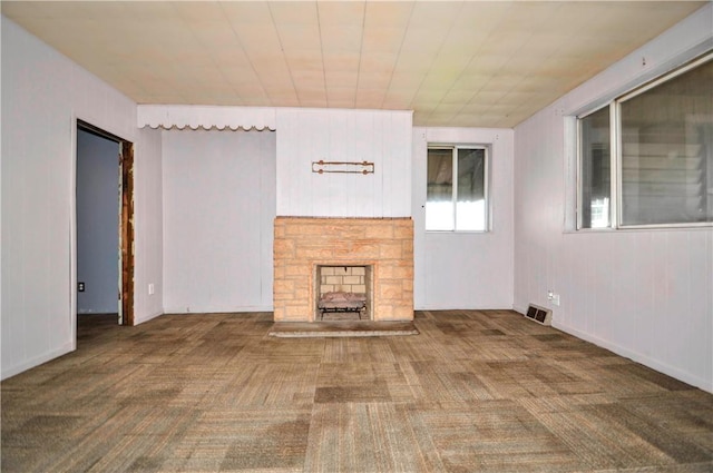 unfurnished living room featuring visible vents, carpet flooring, and a fireplace