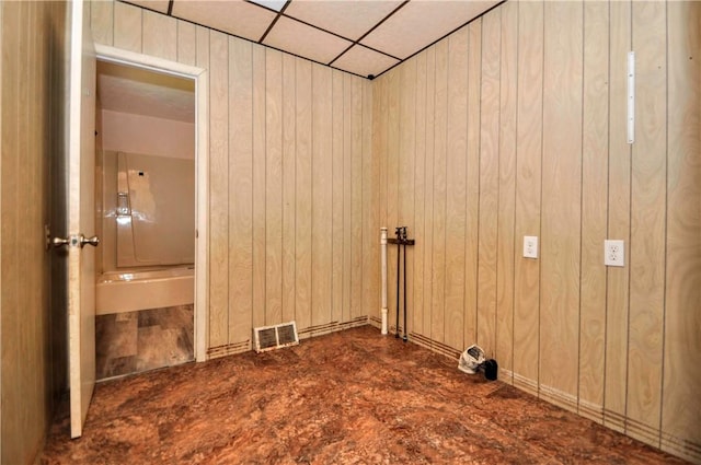 washroom featuring wooden walls and visible vents