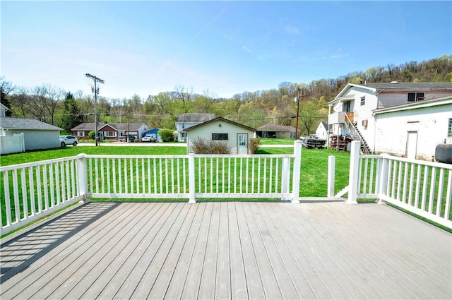 wooden terrace with a yard and a residential view
