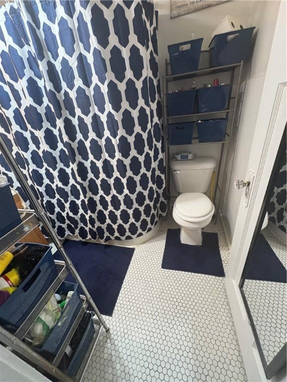 bathroom with tile patterned floors and toilet