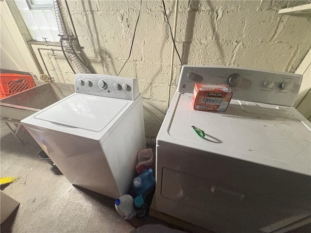 clothes washing area featuring independent washer and dryer and laundry area