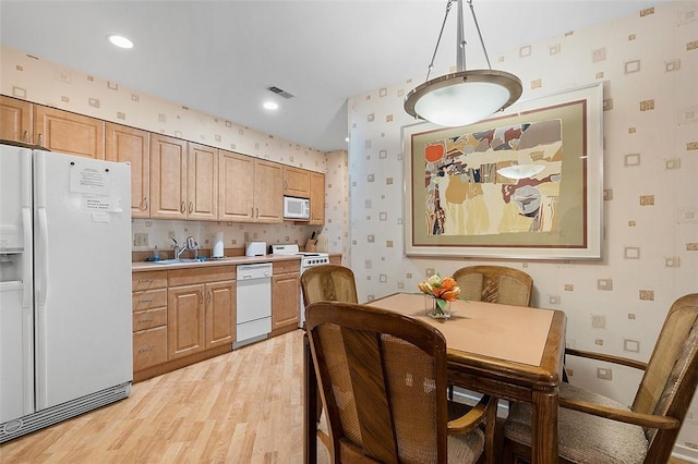 540 N Neville St Unit 402, Oakland, PA 15213 - kitchen featuring a sink, visible vents, light wood-style floors, wallpapered walls, and white appliances