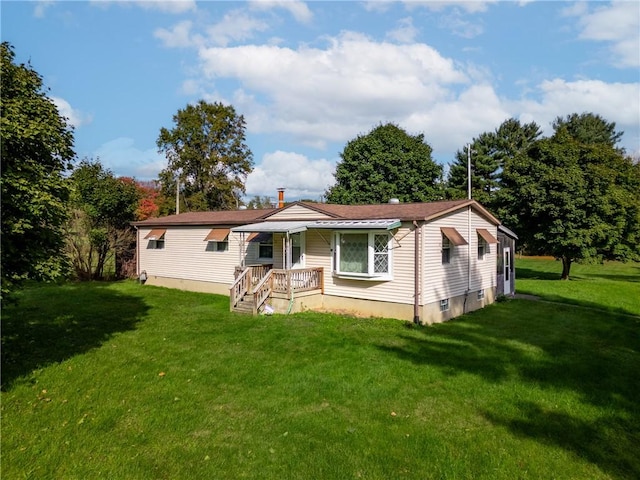 back of property with a lawn