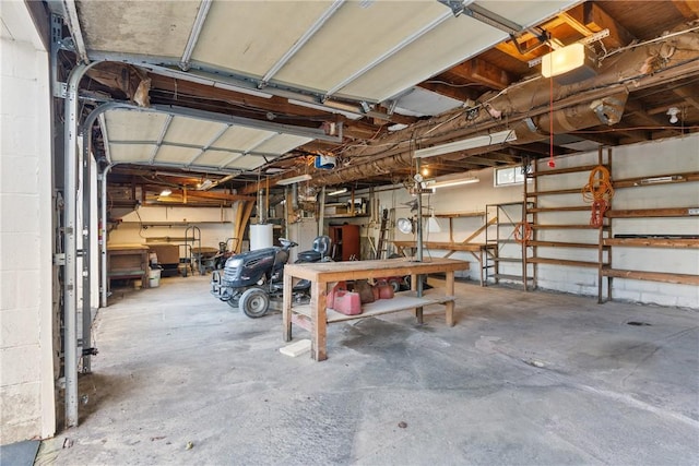 garage featuring water heater and a workshop area