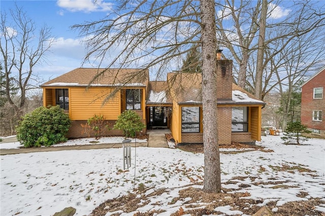 166 Sunset Dr, Wilkins Twp, PA 15235 - view of front of house with a chimney and brick siding