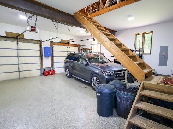 garage featuring electric panel and a garage door opener