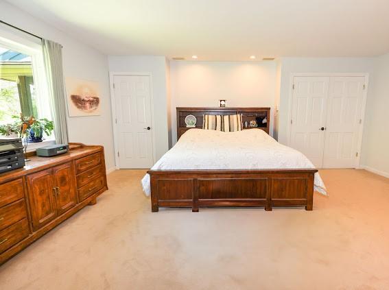 bedroom with light colored carpet, baseboards, and recessed lighting