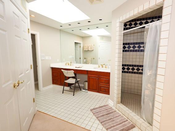full bathroom featuring a shower stall, vanity, and recessed lighting