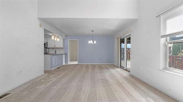 1420 Lexington Dr, Cecil, PA 15055 - interior space with a sink, an inviting chandelier, light colored carpet, baseboards, and visible vents