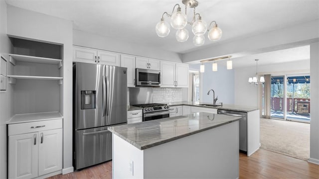 1420 Lexington Dr, Cecil, PA 15055 - kitchen with white cabinets, an inviting chandelier, a sink, a peninsula, and appliances with stainless steel finishes