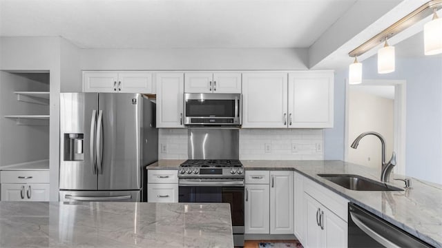 1420 Lexington Dr, Cecil, PA 15055 - kitchen with stainless steel appliances, a sink, white cabinetry, decorative backsplash, and light stone counters