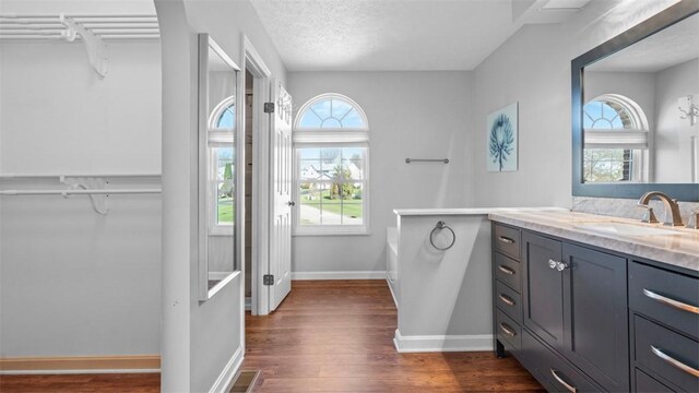 1420 Lexington Dr, Cecil, PA 15055 - full bathroom with a washtub, wood finished floors, vanity, baseboards, and visible vents
