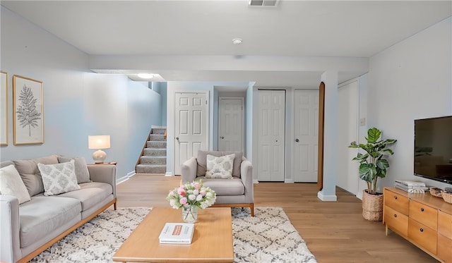 1420 Lexington Dr, Cecil, PA 15055 - living room featuring stairway, baseboards, visible vents, and light wood-style flooring