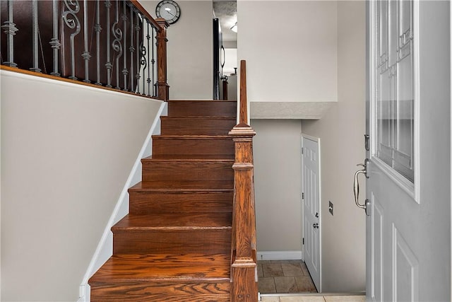 stairway featuring baseboards