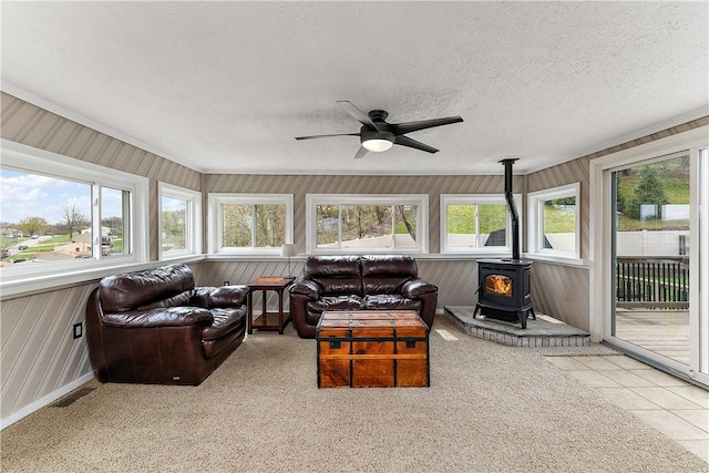 sunroom / solarium with plenty of natural light and a wood stove
