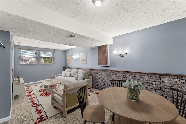 interior space with baseboards, visible vents, a textured ceiling, and carpet flooring
