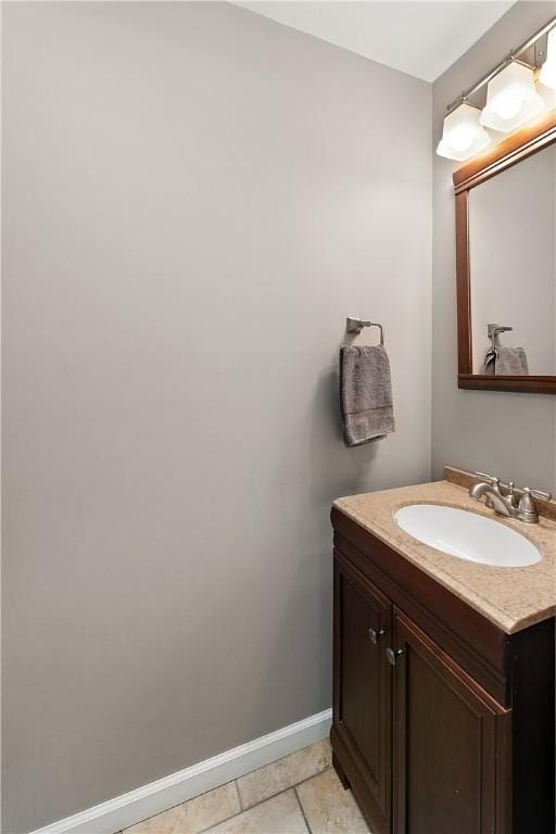 bathroom with baseboards, vanity, and tile patterned floors