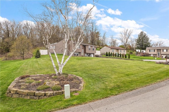 view of front of property featuring a residential view and a front lawn