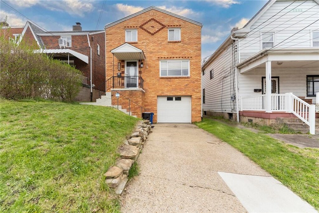 1447 Woodbourne Ave, Brookline, PA 15226 - traditional home featuring brick siding, driveway, a front lawn, and a garage