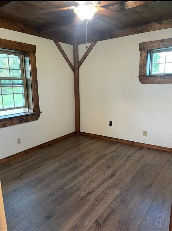 spare room with dark wood-style floors and baseboards