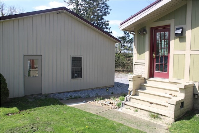 view of property exterior with entry steps and a yard