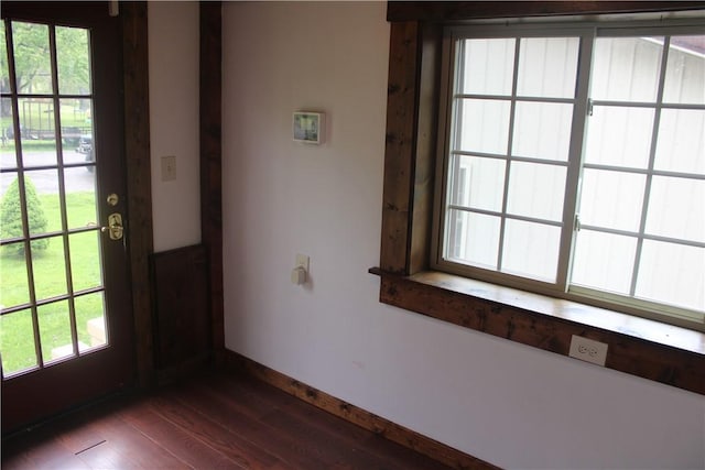 doorway to outside featuring dark wood-style flooring and baseboards