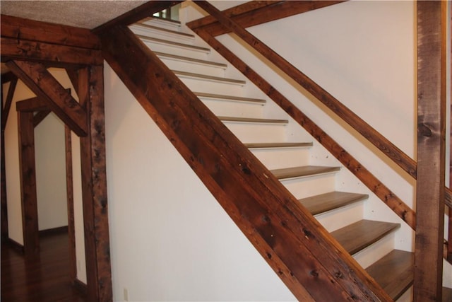 staircase with wood finished floors