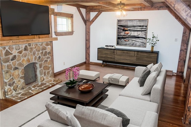 living room with wood finished floors, a fireplace, beamed ceiling, a ceiling fan, and baseboards