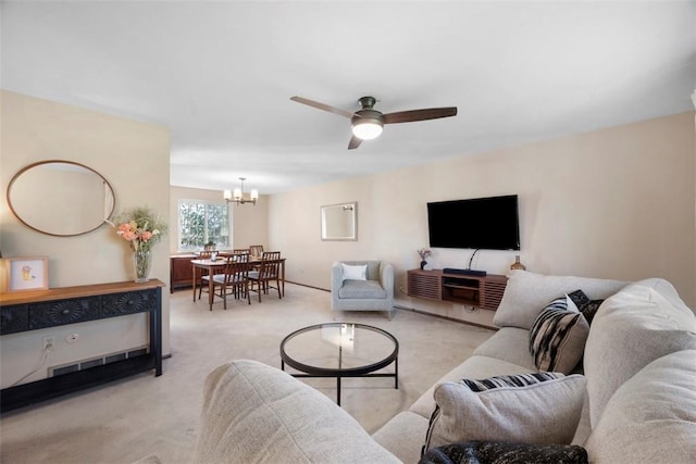 living area featuring light carpet and ceiling fan with notable chandelier