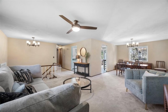 living room with light colored carpet and ceiling fan with notable chandelier