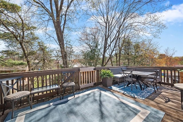 wooden terrace with outdoor dining space