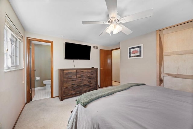 bedroom featuring a ceiling fan, carpet, baseboards, ensuite bath, and visible vents