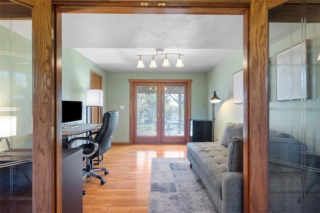 home office featuring light wood-type flooring, baseboards, and french doors