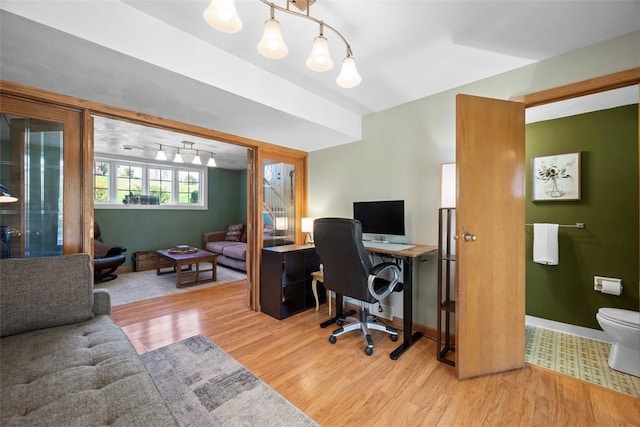home office featuring baseboards and wood finished floors