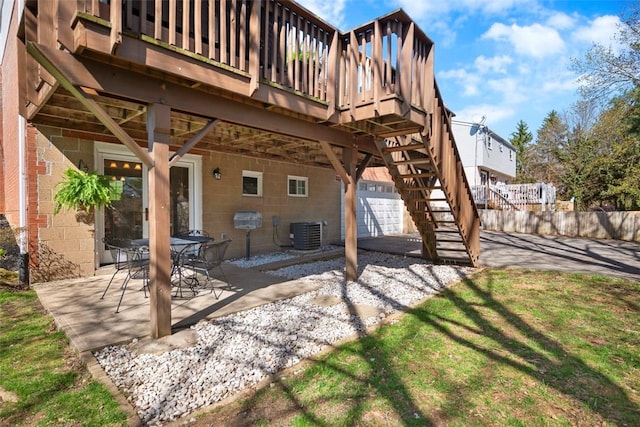 view of patio featuring stairs, central AC unit, and a deck