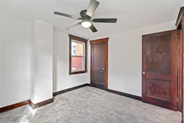 unfurnished bedroom featuring a ceiling fan, baseboards, and carpet floors