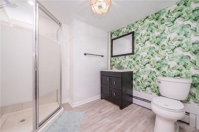 bathroom featuring wallpapered walls, baseboard heating, toilet, an accent wall, and a stall shower