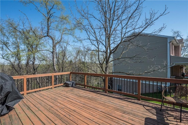 wooden terrace featuring a grill