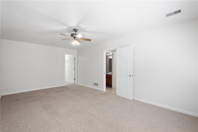 unfurnished bedroom featuring light carpet, baseboards, visible vents, and a ceiling fan